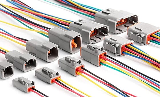 Row of grey Deutsch DT connectors with colored wire leads