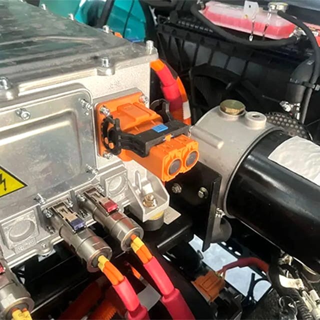 Electric drive unit with orange high-voltage connectors